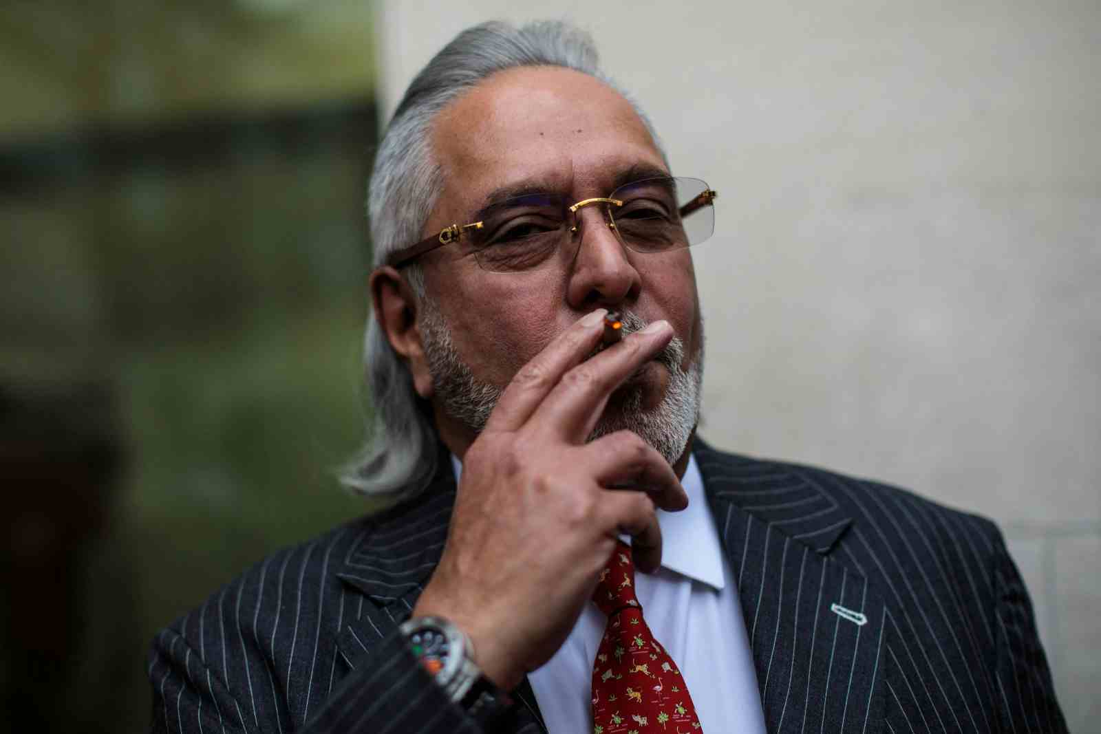 Indian businessman Vijay Mallya smokes during a break in his extradition ruling at Westminster Magistrates Court on December 10, 2018 in London, England (Jack Taylor/Getty Images)