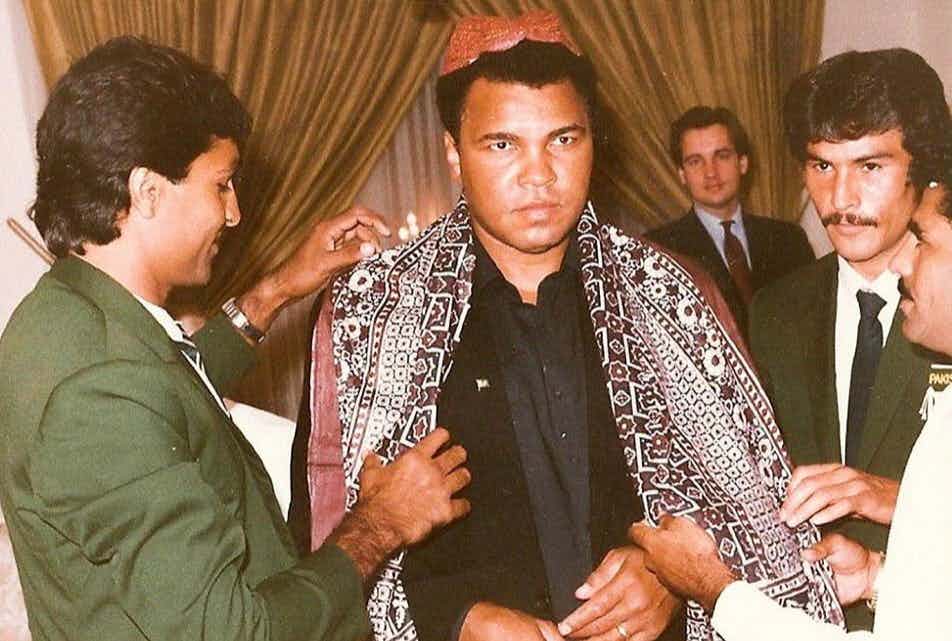 Muhammad Ali visited Pakistan twice, in 1988 and 1989. He’s pictured here being honored with a Sindhi cap and Ajrak. (U.S. Consulate Karachi)