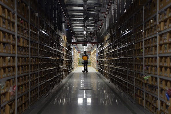 An employee retrieves products at Amazon's newly launched fulfillment center on the outskirts of Bangalore. (Getty)