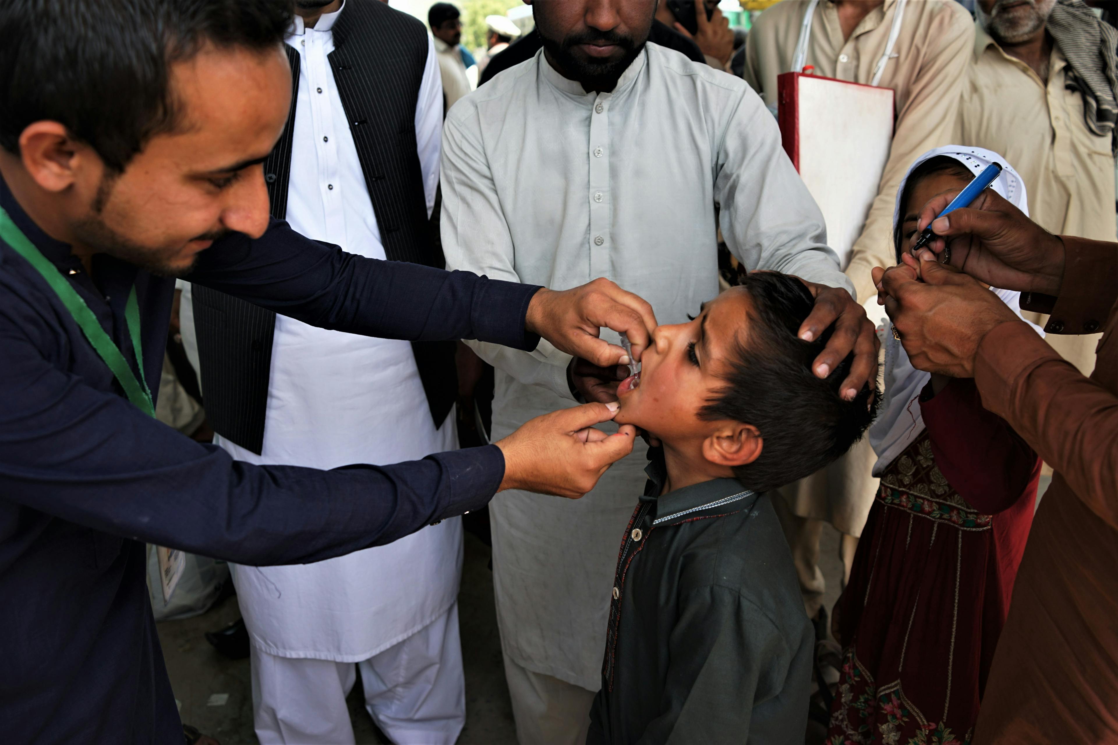 A child receives an oral polio vaccination at a bus terminal in Rawalpindi, Pakistan. (Sabrina Toppa)