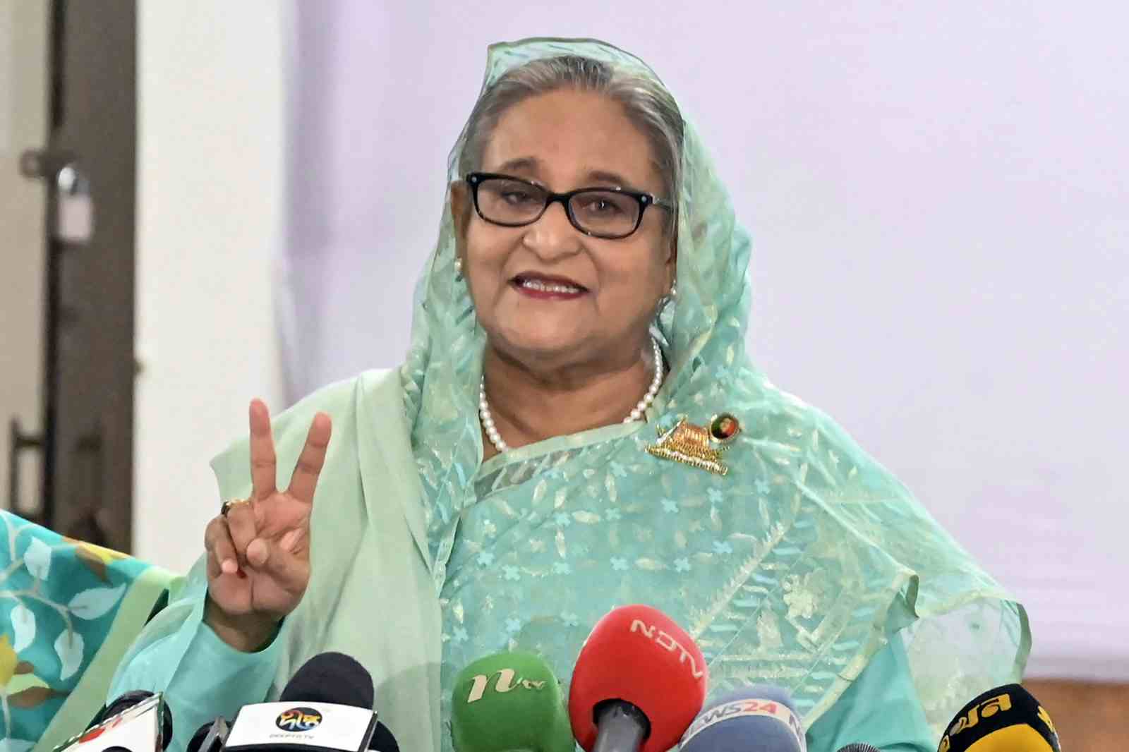 Bangladesh's Prime Minister Sheikh Hasina gestures after casting her vote at a polling station in Dhaka on January 7, 2024 (AFP via Getty Images)