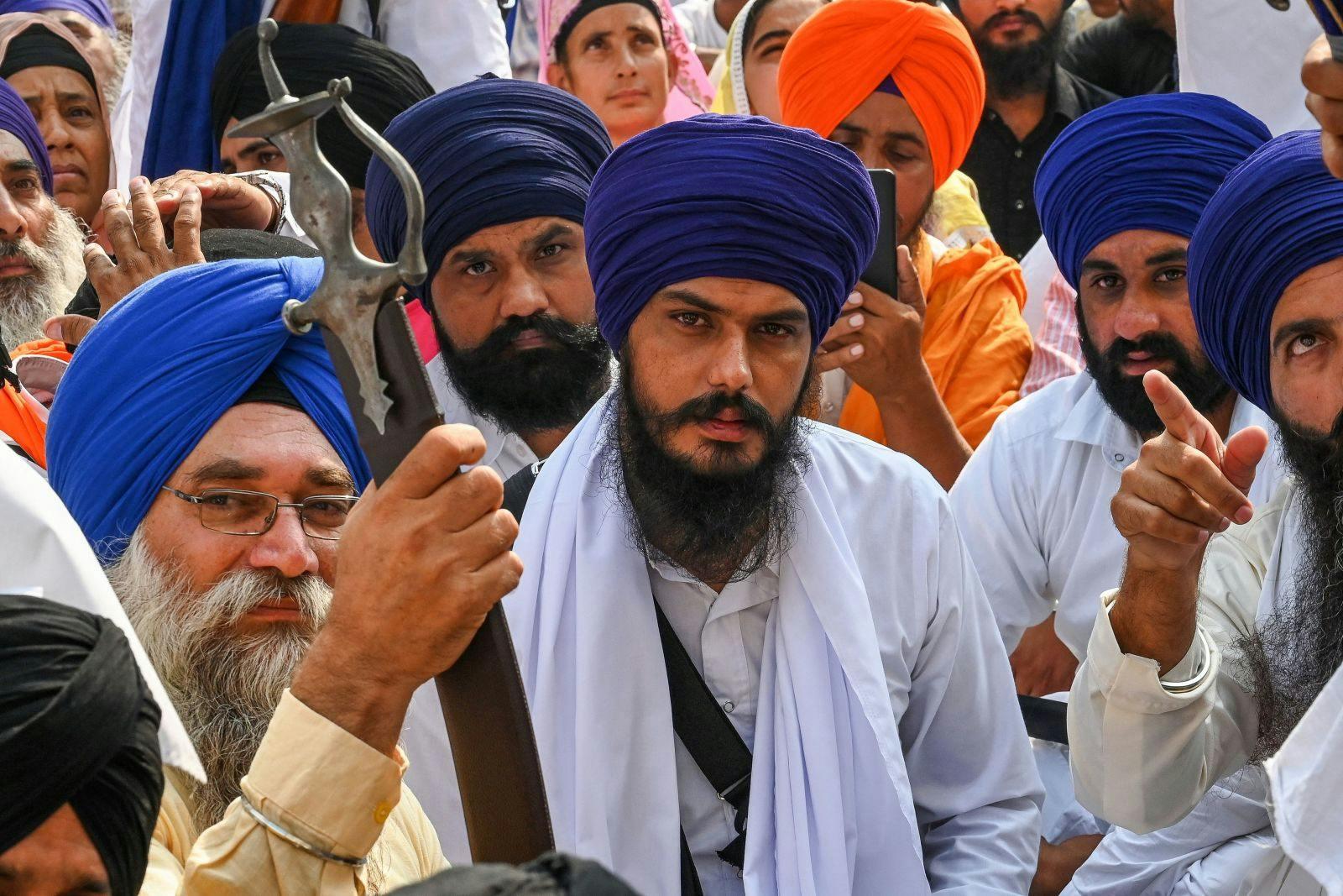 Amritpal Singh (C) along with devotees takes part in a Sikh initiation rite ceremony also known as Amrit Sanskar at Akal Takht Sahib in the Golden Temple in Amritsar on October 30, 2022 (NARINDER NANU/AFP via Getty Images)
