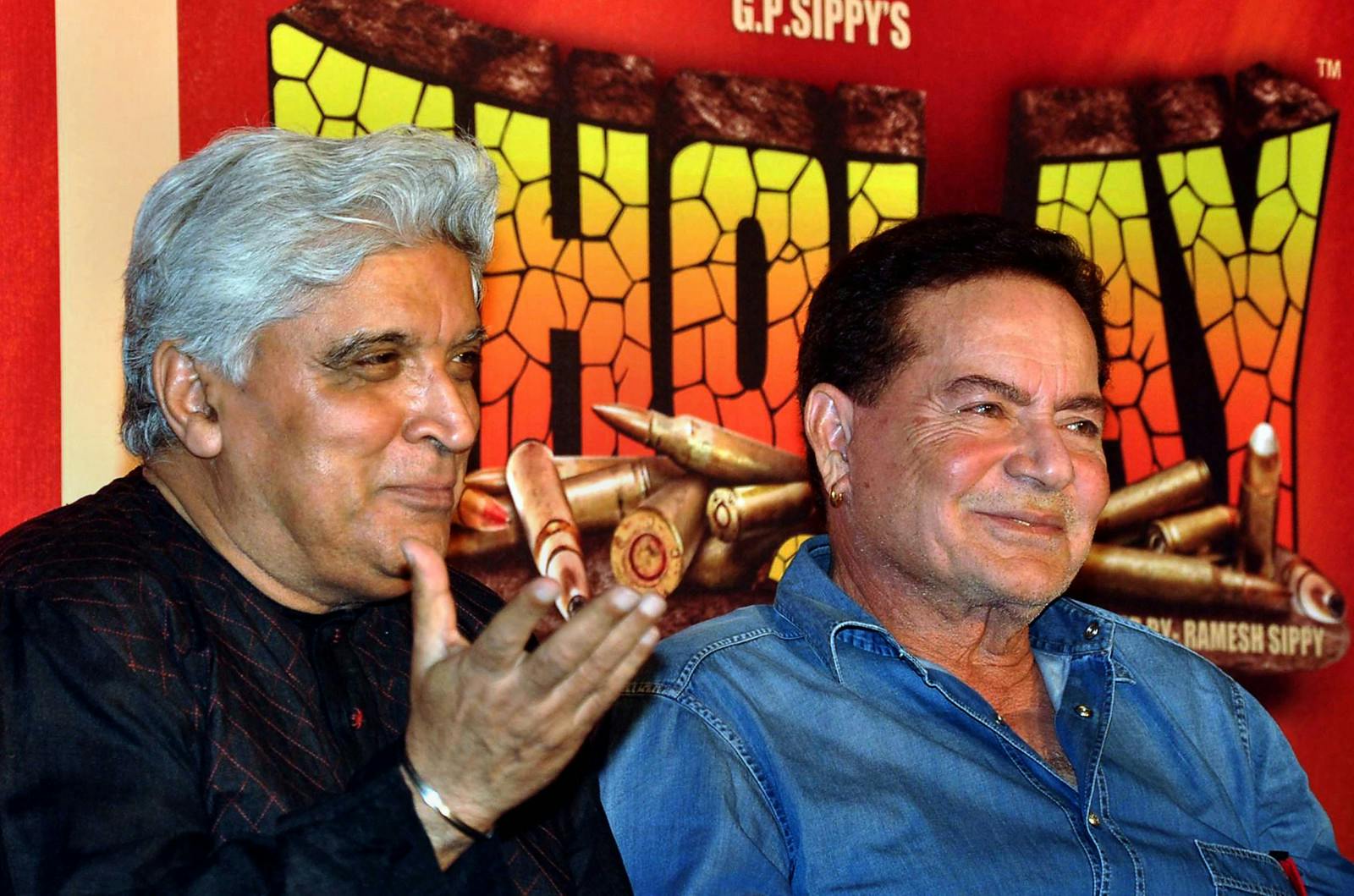 Indian Bollywood scriptwriters Javed Akhtar (L) and Salim Khan (R) speak to media at a promotional event for the film Sholay, re-released in 3D, on November 7, 2013 (STRDEL/AFP via Getty Images)