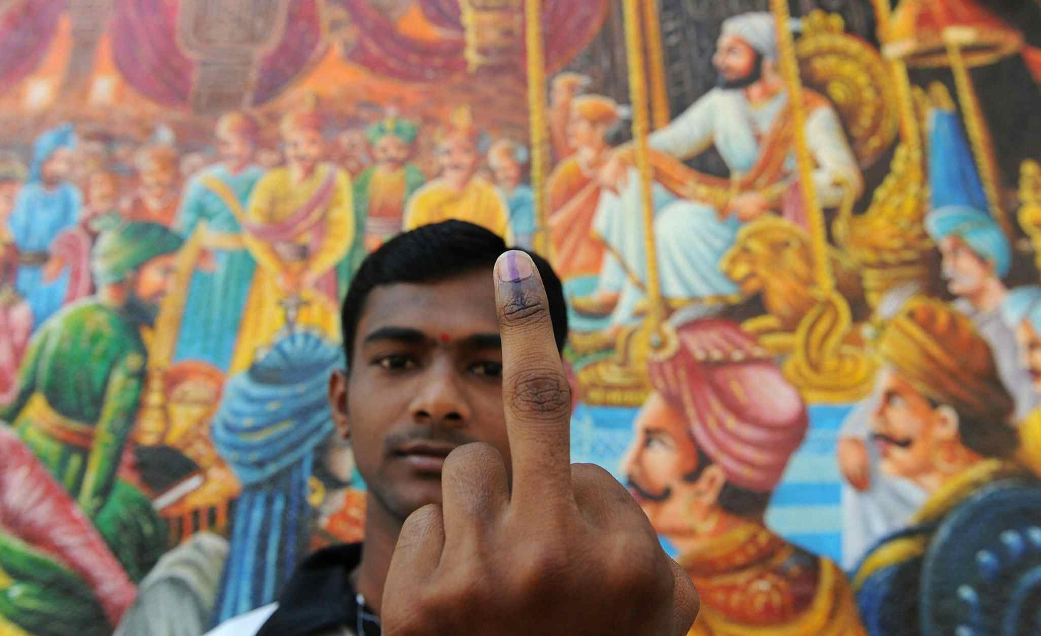 First time Indian voter Rajesh Vichare displays the indelible ink mark that shows he has cast his vote at a primary school in Kondgaon village of Raigad district of Maharashtra on April 23, 2009 (INDRANIL MUKHERJEE/AFP via Getty Images)