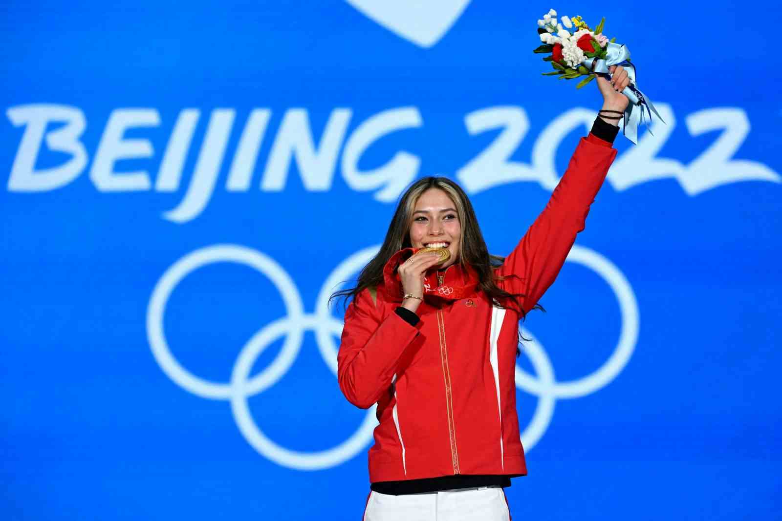 Gold medalist Eileen (Ailing) Gu of China celebrates her women's big air victory at the Beijing Medals Plaza in Beijing on February 8, 2022. (MANAN VATSYAYANA/AFP via Getty Images)