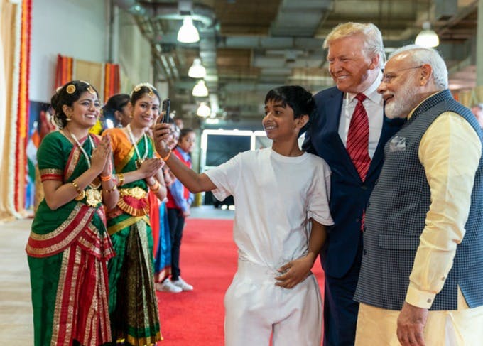 President Donald J. Trump and Prime Minister Narendra Modi pose for a selfie with a group of people at a rally in honor of PM Modi at NRG Stadium in Houston, Texas, 2019. (Creative Commons)