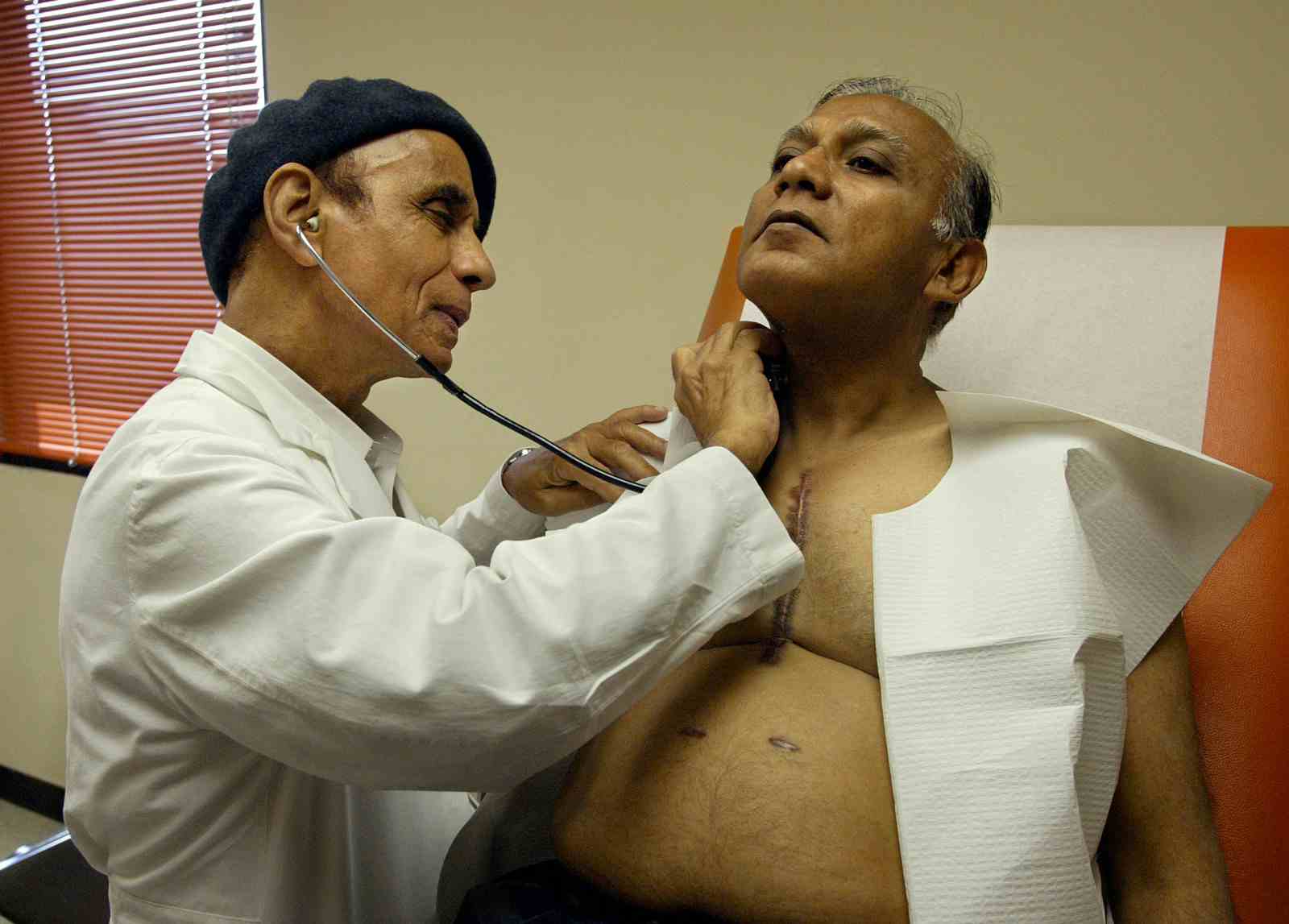 Dr. Moneim Fadali, cardiovascular and thoracic surgeon, examines patient Ahmed Muhnee during a heart and lung evaluation at his office in Los Angeles (Mel Melcon/Los Angeles Times via Getty Images)