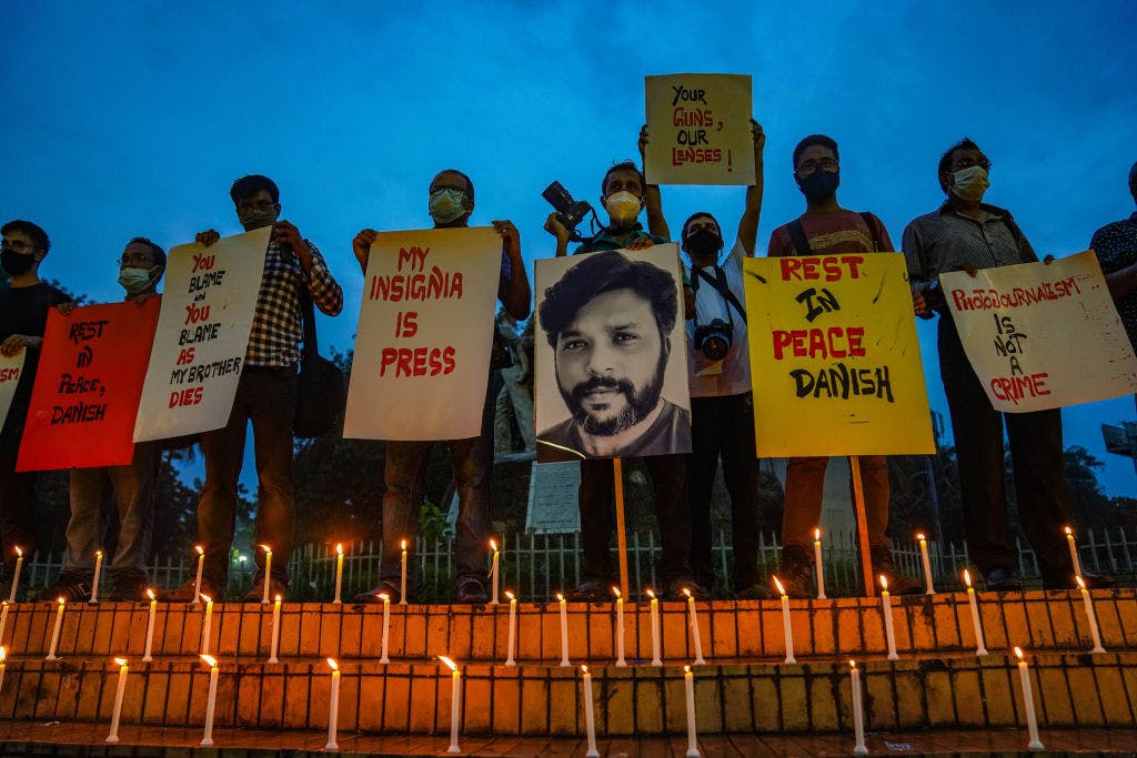 Bangladeshi journalists light candles, hold placards and a portrait of Reuters journalist Danish Siddiqui, in his tribute. (Photo by Zabed Hasnain Chowdhury/SOPA Images/LightRocket via Getty Images)