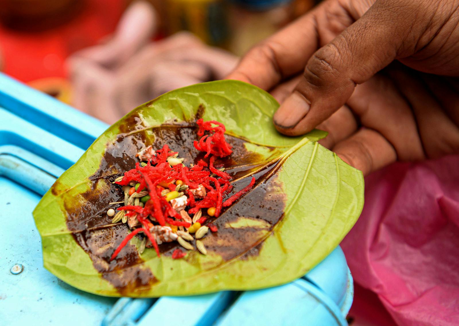 Meetha paan, made of betel leaves filled with tutti-frutti, cherries, dates, betel (areca) nut, slaked lime (chuna; calcium hydroxide) in Little India, Phahurat Market, Bangkok, Thailand (Paul Lakatos/SOPA Images/LightRocket via Getty Images)