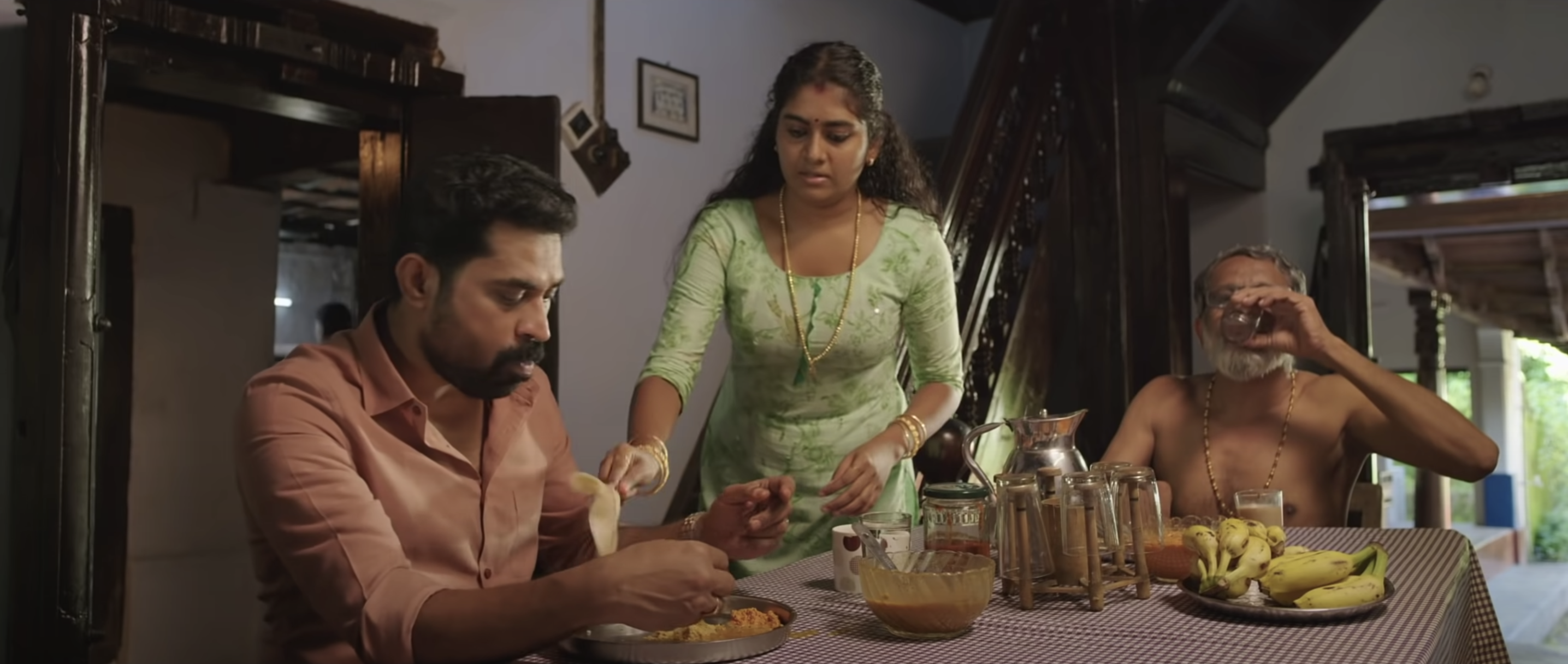 Suraj Venjaramoodu, Nimisha Sajayan, and T. Suresh Babu in 'The Great Indian Kitchen' (Mankind Cinemas/Symmetry Cinemas/Cinema Cooks, 2021)
